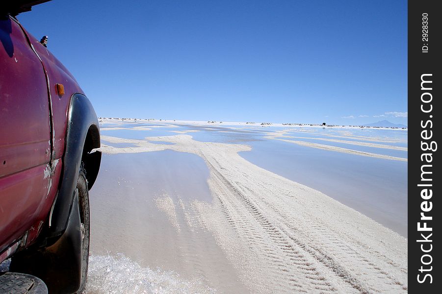 The outside of a truck driving across salt plains in Uyuni in Bolivia. The outside of a truck driving across salt plains in Uyuni in Bolivia.