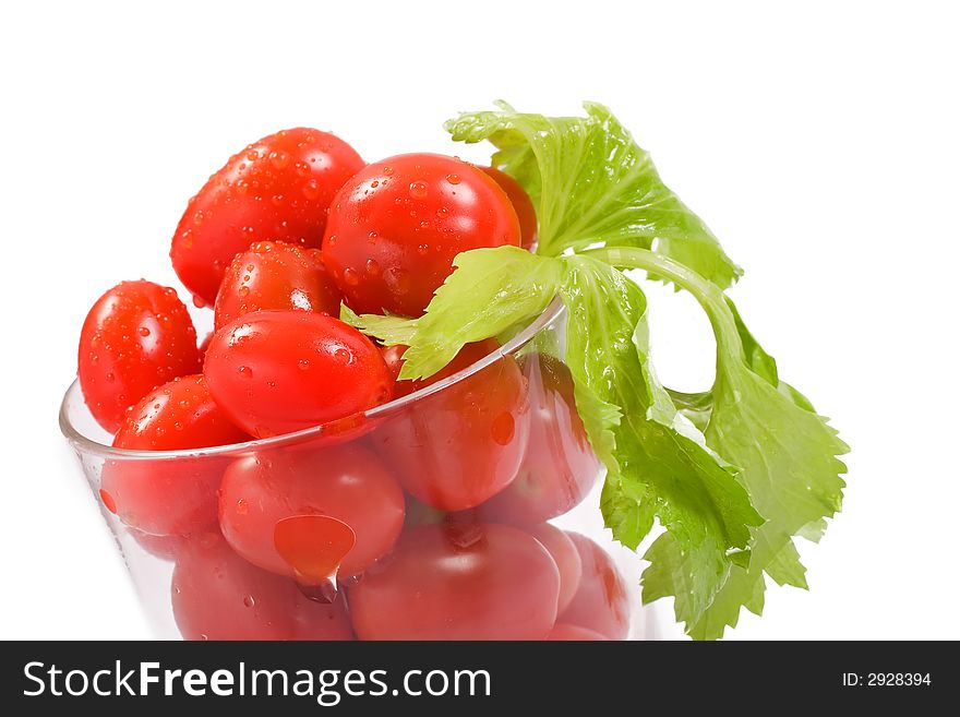 Tomatoes in a glass with leafy celery stalk. Tomatoes in a glass with leafy celery stalk