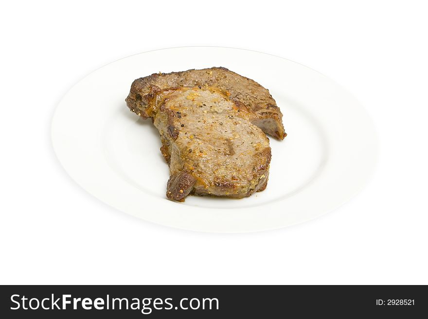 Fresh grilled rib-eye steak isolated on a white background. Fresh grilled rib-eye steak isolated on a white background