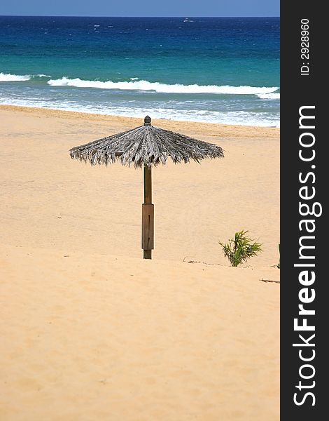 Lonely sun shade on a beach