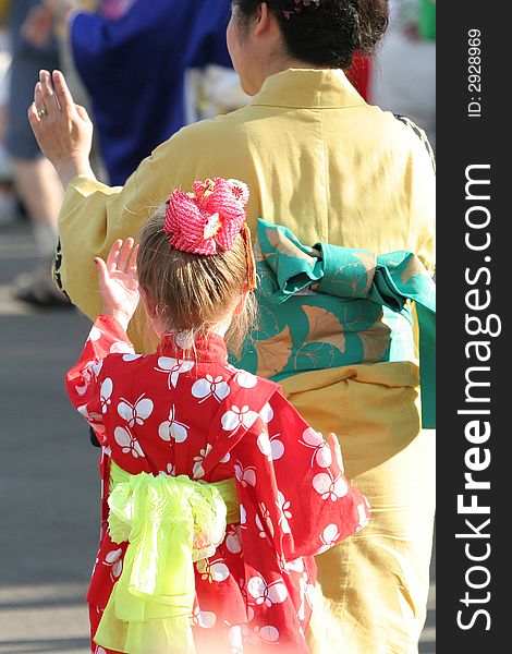 Little girl learning how dance a Japanese folk dance. Little girl learning how dance a Japanese folk dance.