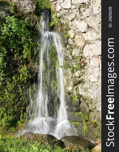Small countryside waterfall with vegetation