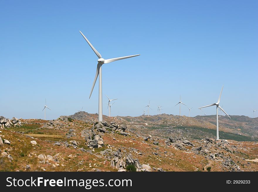 Wind power generators farm against blue sky