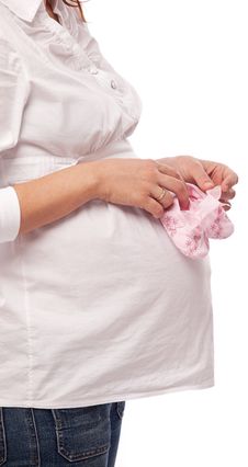Pregnant Woman Keeping Pink Baby-shoes. Royalty Free Stock Photography Pregnant Woman Keeping Pink Baby-shoes. Royalty Free Stock Photography