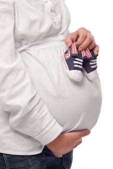 Pregnant Woman Keeping Baby-shoes Stock Photo Pregnant Woman Keeping Baby-shoes Stock Photo