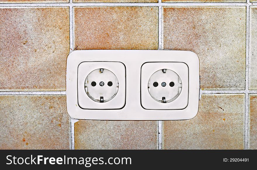 White electrical outlets on the tiled wall