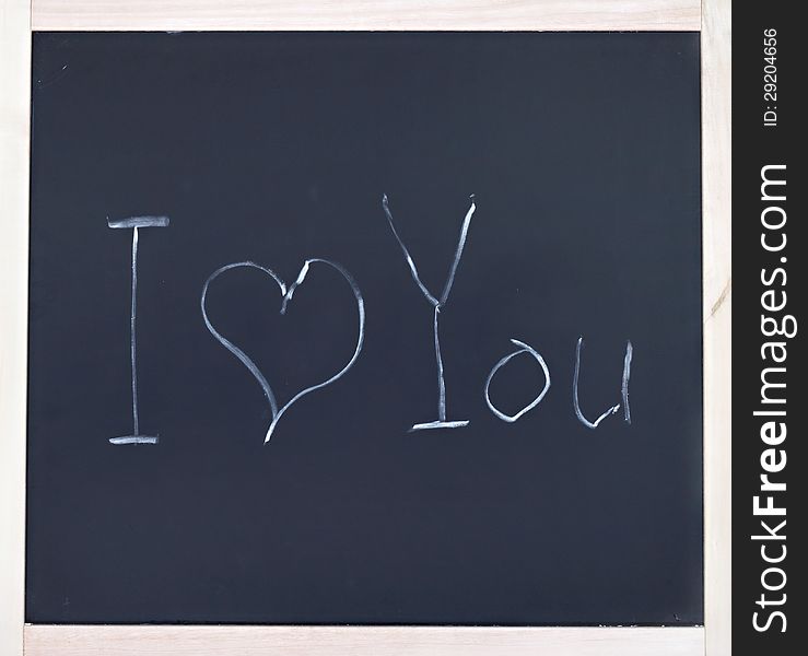 Phrase I love you drawn in chalk on blackboard