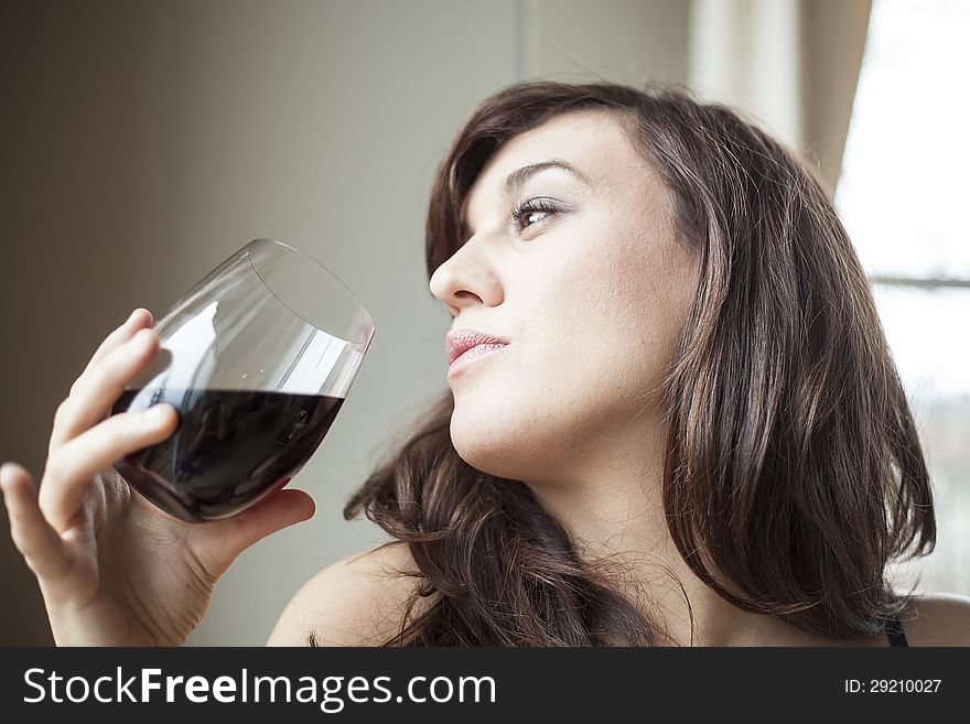 Young Woman in Lingerie Drinking Red Wine