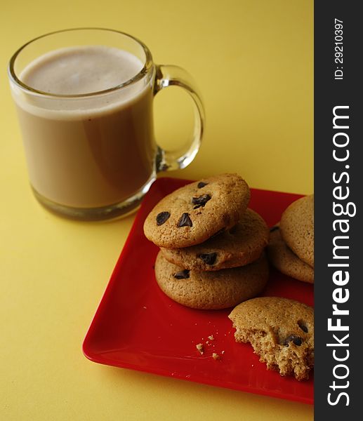 mug of coffee with chocolate chip cookies on red plate hot coco. mug of coffee with chocolate chip cookies on red plate hot coco