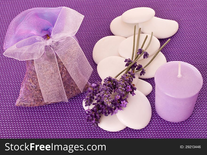 Little sack of lavender with lavender blossoms over violet background