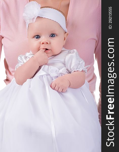 Newborn baby girl on mother hands in white dress