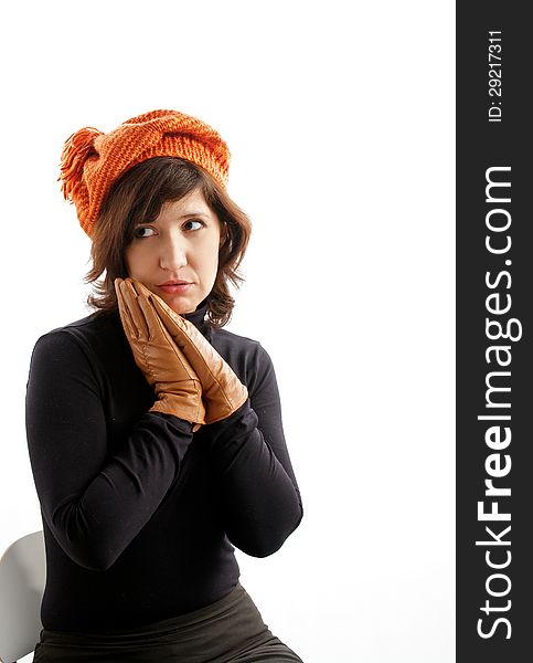 Young Attractive Woman Sitting in Knitting Hat and Gloves and Asks Where is my Fur Coat?