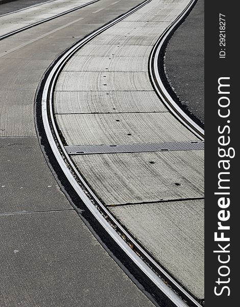 Silvery grey tramlines curve through street in central Europe
