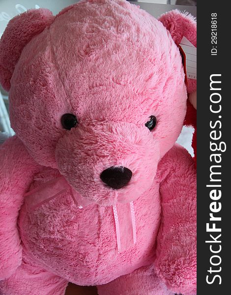 Pink teddy bear have a black eye. Pink teddy bear have a black eye.