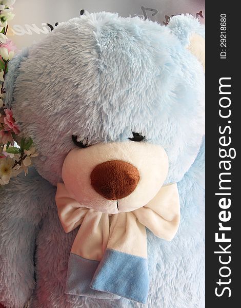 Sky blue teddy bear have a black eye. Sky blue teddy bear have a black eye.