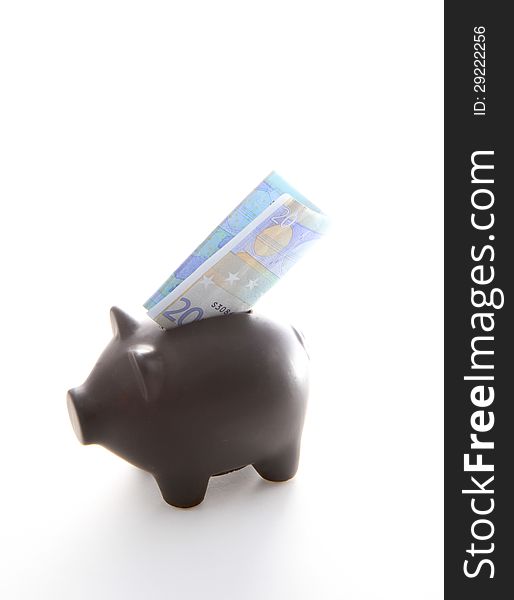 A black piggybank with money on a white background