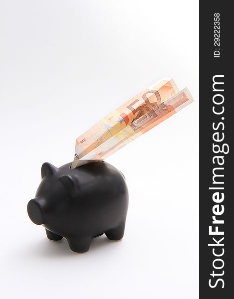 A black piggybank with an airplane of money on a white background