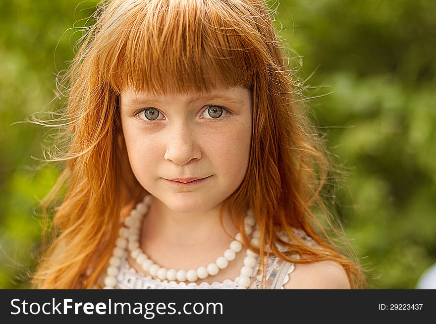 Little redheaded girl on the nature