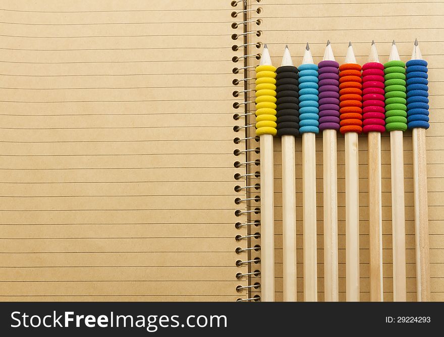 Full-frame image of group of pencil with various colours holder laying on spiral. Full-frame image of group of pencil with various colours holder laying on spiral