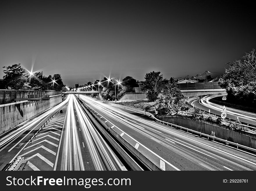 Black and white photo of headlight tracks on Toulouse circular highway. Black and white photo of headlight tracks on Toulouse circular highway