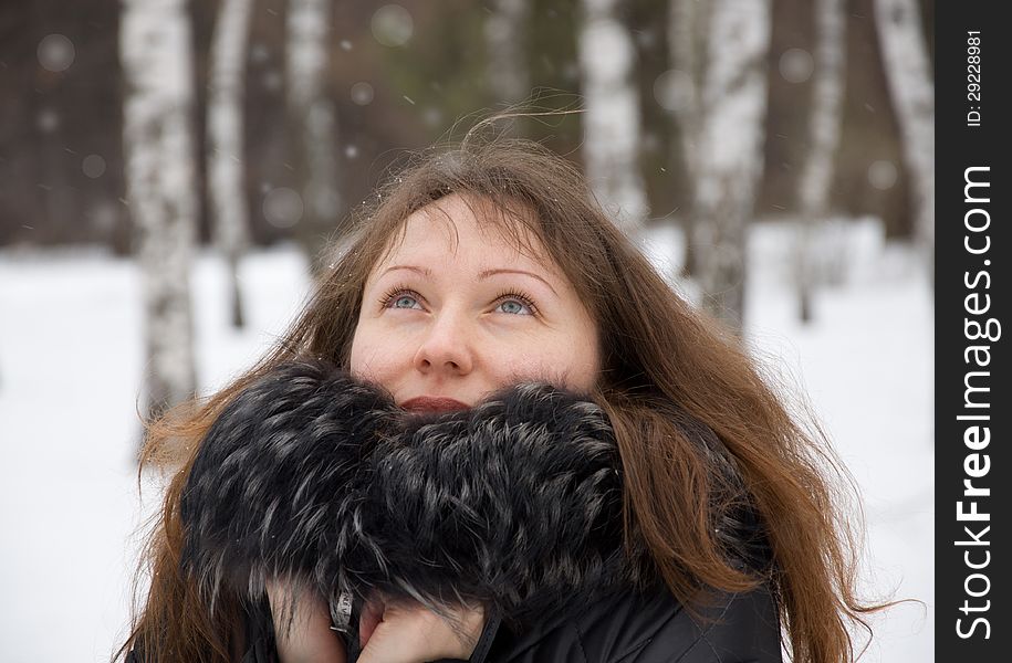 Brunette woman in snow winter park