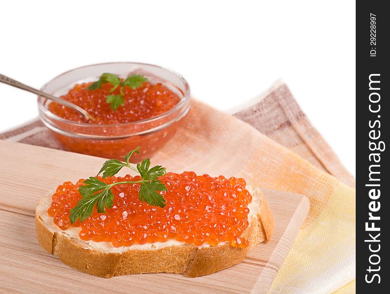 Bread with red caviar and parsley