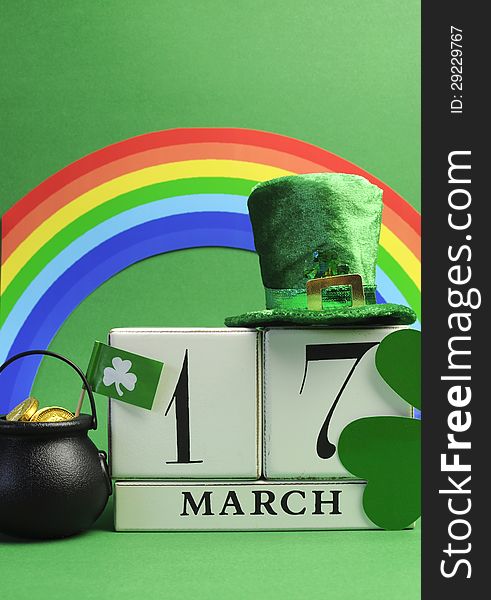 Save the date white block calendar for St Patrick's Day, March 17, with Leprechaun hat, pot of gold, and rainbow, on green background. Save the date white block calendar for St Patrick's Day, March 17, with Leprechaun hat, pot of gold, and rainbow, on green background.