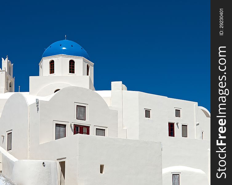 White walls of the city's buildings are decorated with blue domes. Their color competes with the color of the sky. White walls of the city's buildings are decorated with blue domes. Their color competes with the color of the sky.