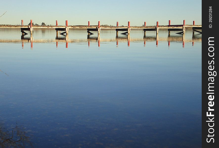 Pier reflected on a calm lake