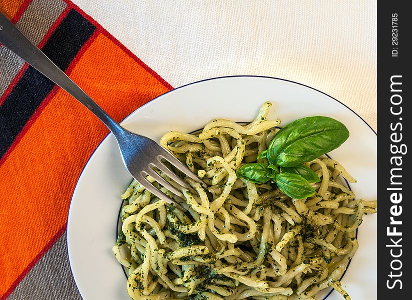 A plate of pasta with pesto