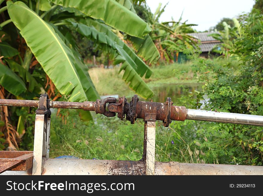 The rusty old shaft of the pump. The rusty old shaft of the pump