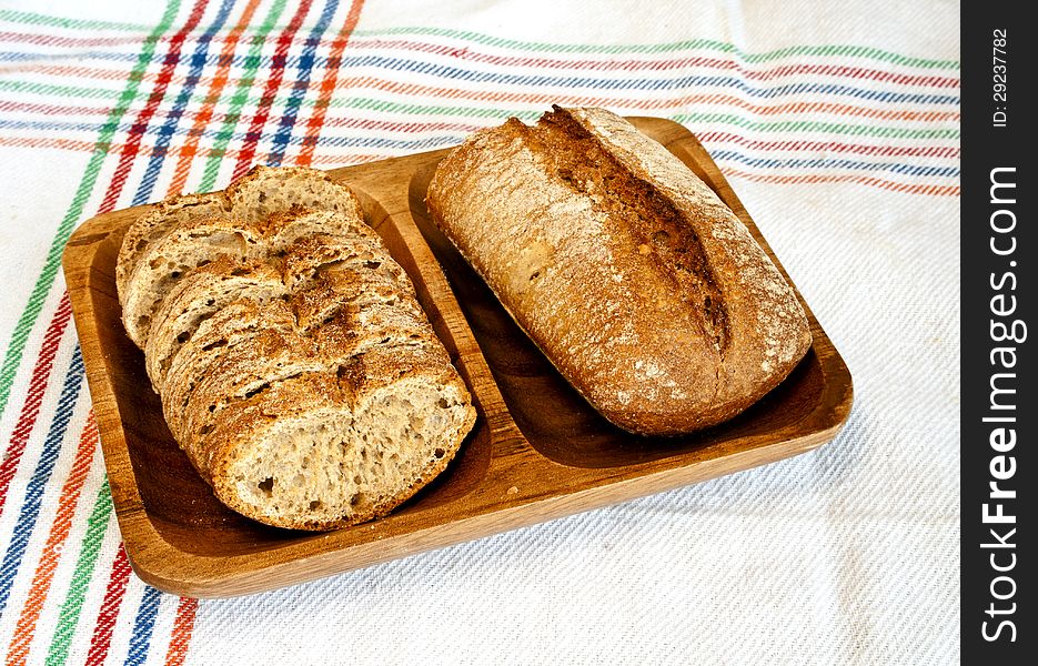 Sliced rye bread on wooden plate