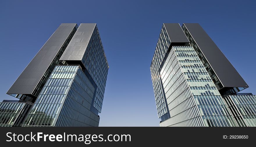 Urban view at modern glass building with blue sky. Urban view at modern glass building with blue sky