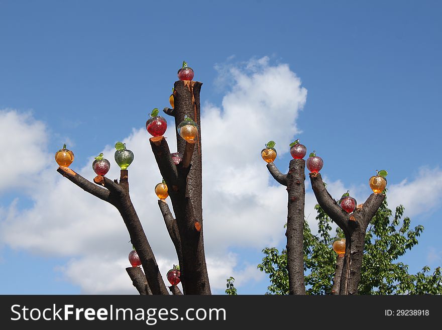 Handmade colored glass apples and put in tree