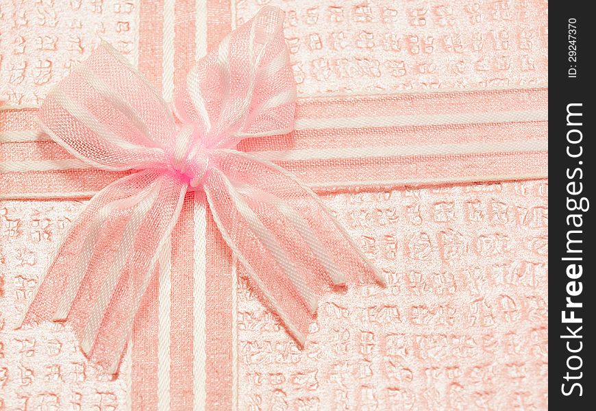 Bright pink ribbon on a pink background. Bright pink ribbon on a pink background