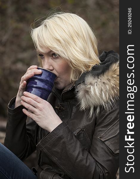 Portrait of a blonde woman holding a cup of coffee. Portrait of a blonde woman holding a cup of coffee.