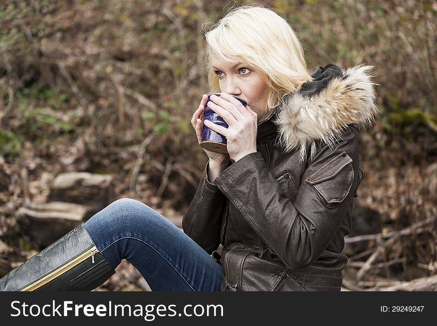 Portrait of a blonde woman holding a cup of coffee. Portrait of a blonde woman holding a cup of coffee.