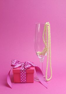 Pretty Pink And Feminine Gift With Polka Dot Pink Ribbon And A Champagne Glass With Pearls Royalty Free Stock Image Pretty Pink And Feminine Gift With Polka Dot Pink Ribbon And A Champagne Glass With Pearls Royalty Free Stock Image