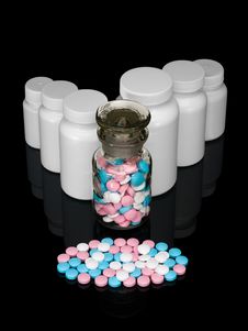 Small Group A Pill Against Small Bottles With Pills. Royalty Free Stock Photography