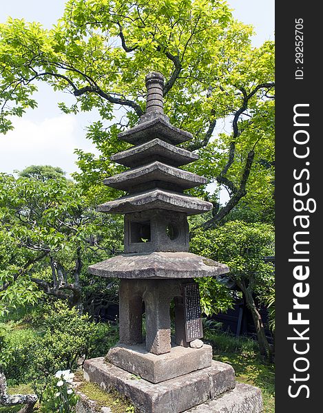 Ancient stone lantern inside summer zen garden. Ancient stone lantern inside summer zen garden