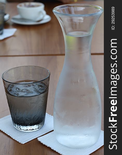 Glass iced and water bottle on table. Glass iced and water bottle on table