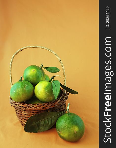 Green citrus in a basket