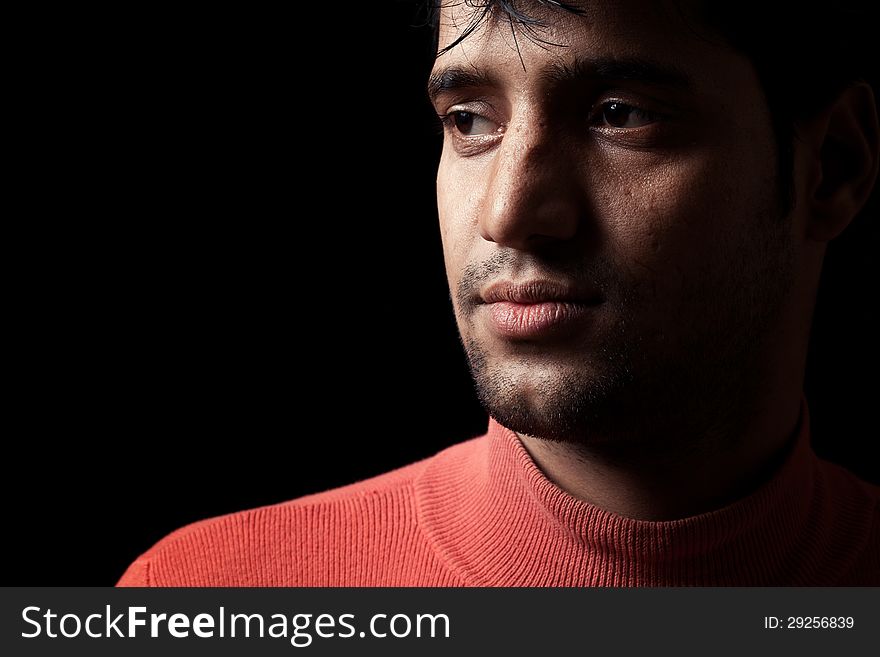 Portrait Of Young Indian  Man Over Dark