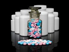 Small Group A Pill Against Small Bottles With Pills. Stock Images Small Group A Pill Against Small Bottles With Pills. Stock Images