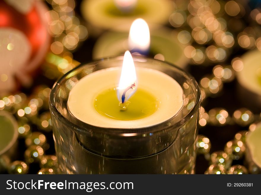 Burning candle on a background blur. Burning candle on a background blur