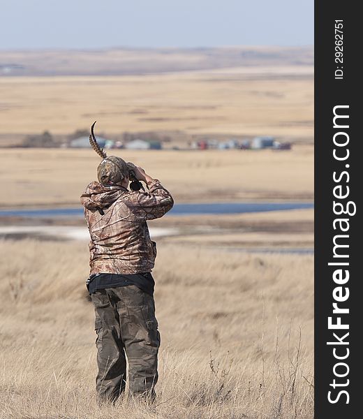 Boy looking for game with binoculars. Boy looking for game with binoculars