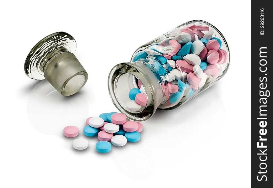 Glass vial with a glass stopper and group a pill on a white background. Glass vial with a glass stopper and group a pill on a white background