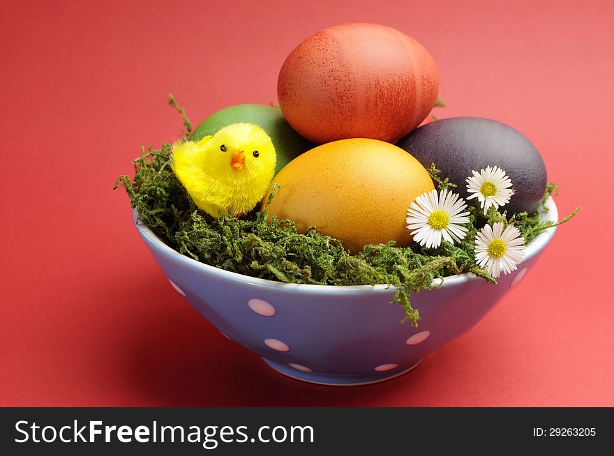 Happy Easter Still Life With Rainbow Color Eggs Against A Red Background.