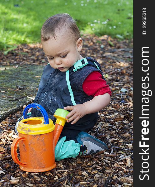 Child playing with watering can