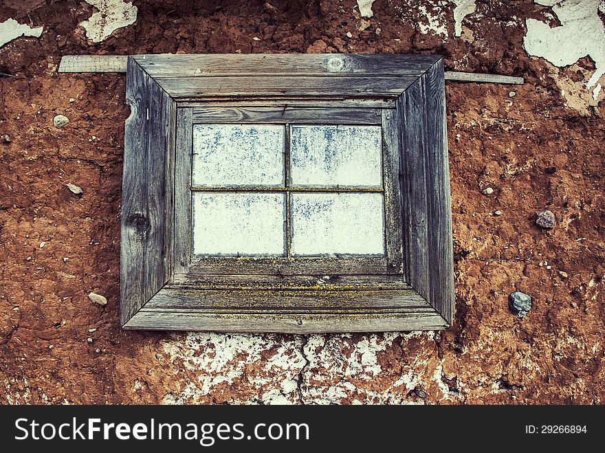 Window on a facade of the old clay house